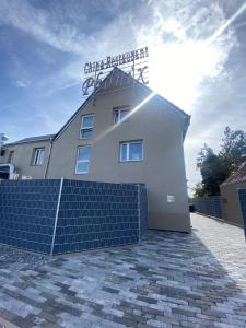 a white building with blue solar panels in front of it at PHOENIX Apartments - Monteurwohnung mit RIESIGER Parkfläche in Bielefeld