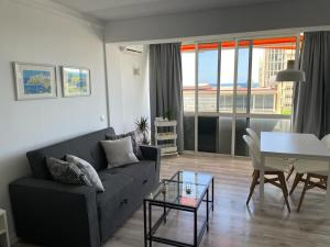 a living room with a couch and a table at Apartamento C y L in Torremolinos
