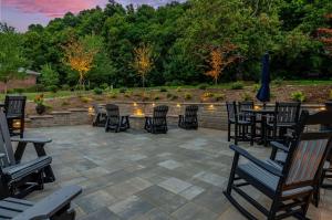 a patio with chairs and tables and a fountain at Graystone Lodge, Ascend Hotel Collection in Boone