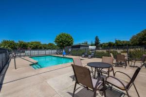 a patio with a table and chairs next to a pool at Quality Inn Yuba City-Marysville in Yuba City
