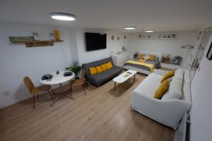 a living room with a couch and a table at Central Brighton modern one bed apartments in Brighton & Hove