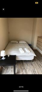 a bedroom with a bed and a table with a night stand at Guesthouse - Oslo Centrum in Oslo