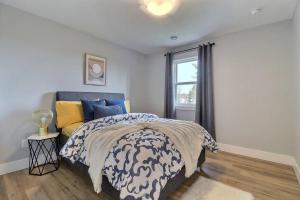 a bedroom with a bed and a window at Beautiful Home in Moncton North! in Moncton