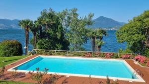 a swimming pool with a view of the water at La Suite dell'Artista LUXURY ART SUITE in Stresa