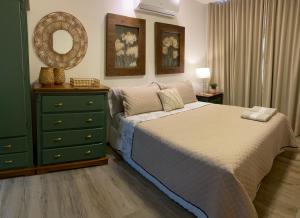 a bedroom with a bed and a dresser and a mirror at Apartamento na Vila de Barra Grande - Bahia in Barra Grande +29 photos