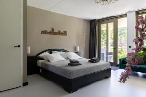 a bedroom with a bed with towels on it at Luxury room with king size bed in Dordrecht