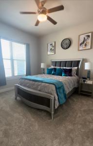 a bedroom with a large bed with a ceiling fan at SAVINGS ON WKLY & MTHLY STAYS! N Heart Of Dallas! in Dallas