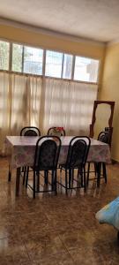 a dining room table with four chairs around it at Kenny G in Tinogasta