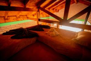 a bedroom with a bed with a teddy bear on it at Chalés Corucacas in Cambará