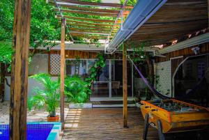 a porch with a bed on a wooden deck at Hacienda Sarah in Nosara