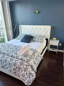 a bedroom with a white bed with a blue wall at Lakeview Condo in Downtown with Free Parking. in Toronto