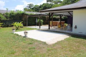 a backyard with a patio and a pavilion at Villa Rubis - proche aéroport in Matoury