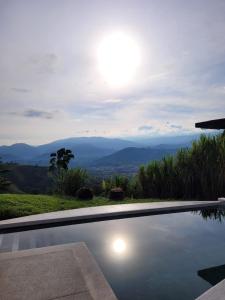 a swimming pool with a view of the mountains at FINCA LA FORTALEZA in Santa Rosa de Cabal