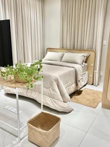 a bedroom with a bed and a table with a plant at Loft Boho - Cosmopolitan - Oktoberfest in Blumenau