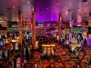 a casino filled with lots of slot machines at Pleasant Unit at New York New York Strip Las Vegas in Las Vegas