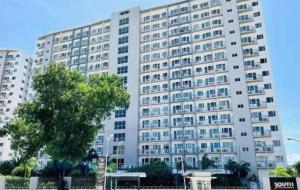 a large white building with a tree in front of it at Stylish 1BR Condo @ SM Southmall in Manila