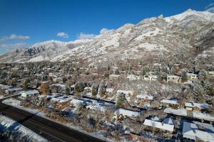 an aerial view of a town with snow covered mountains at Cottonwood Heights - Lower Level of Mountain Home! in Cottonwood Heights