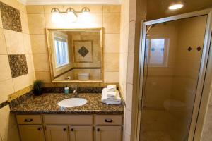 a bathroom with a sink and a mirror and a shower at Cottonwood Heights - Lower Level of Mountain Home! in Cottonwood Heights +25 photos