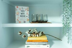 a shelf with books and glasses and a book at Cottonwood Heights - Lower Level of Mountain Home! in Cottonwood Heights