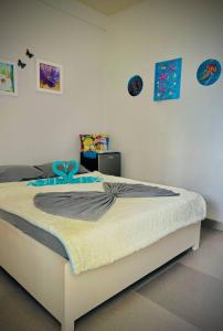 a bed in a bedroom with paintings on the wall at Playa Blanca Beach Resort in Puerto Galera