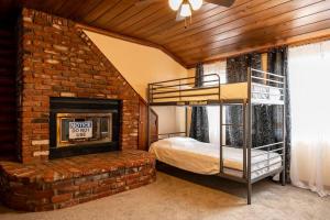 a bedroom with a bunk bed and a brick fireplace at Pine Mountain Club Family Vacation House in Pine Mountain Club +58 photos
