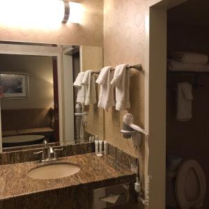 a bathroom with a sink and a mirror at Comfy Unit at Orleans Casino Strip Las Vegas in Las Vegas