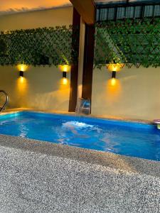 a swimming pool with a water fountain in it at Impiana Pool House Seri Manjung in Seri Manjung