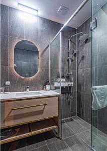 a bathroom with a sink and a shower at Hotel SUMMIT in Gwangju
