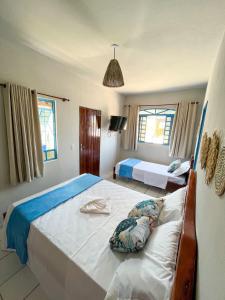 Łóżko lub łóżka w pokoju w obiekcie Pousada Praias do Norte