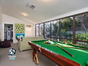 a pool table in a living room with a pool table at Absolute Beachfront 3BR 2BA Home w/ Beach Track in McCracken