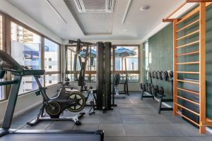a gym with treadmills and exercise equipment in a building at Flat de luxo Rooftop 201 in Recife