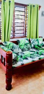 a couch with green curtains in a room at Casa da Luna Watamu Kenya in Watamu