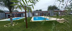 a house with a swimming pool in a yard at Cabañas Don Tatin in La Banda