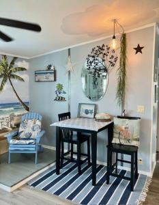 a dining room with a table and chairs at Coastal Imagination Oasis in Davenport