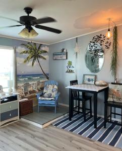 a living room with a dining room table and a living room with a beach at Coastal Imagination Oasis in Davenport