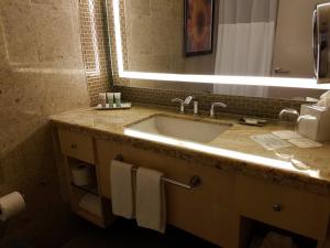 a bathroom with a sink and a mirror at Restful Unit at Mirage Casino Strip Las Vegas in Las Vegas