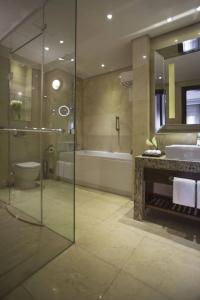 a bathroom with a shower and a sink and a tub at Restful Unit at Mirage Casino Strip Las Vegas in Las Vegas