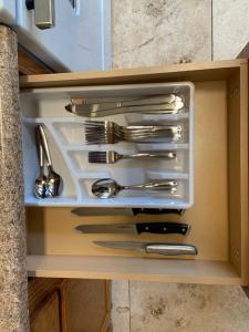 a drawer full of utensils in a cabinet at Bella Oasis Family Retreat in El Mirage