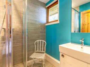 a bathroom with a shower and a chair next to a sink at Appartement Val-d'Isère, 4 pièces, 7 personnes - FR-1-694-91 in Val-d'Isère