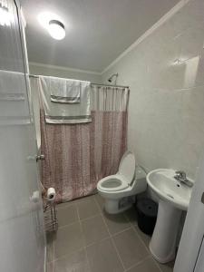 a bathroom with a toilet and a sink at OceanView 2 in Guayama