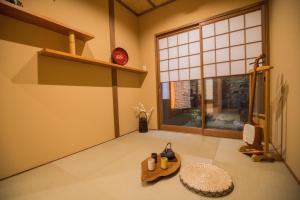 a living room with a table and a window at 京町　朱雀 in Kyoto