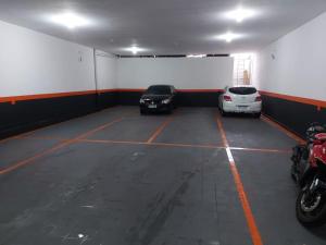 a parking garage with two cars parked in it at Hotel Caliente in Sao Paulo