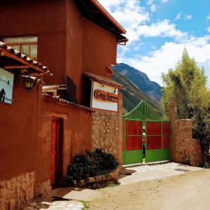 a building with a green door and a sign on it at Casa Saywa in Urubamba