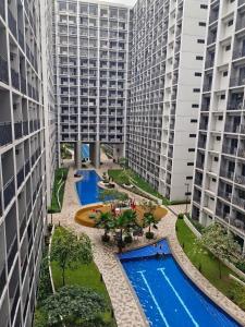 an aerial view of two tall buildings with two pools at Mall of Asia Shore 2 Condo in Manila