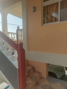 een trap in een huis met een raam bij Sea View Guest Accommodation in Roseau