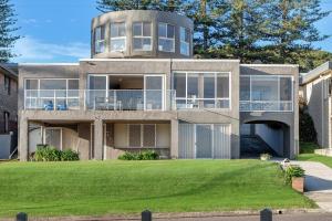 a large concrete house with a large yard at The Rotunda, Gerroa in Gerroa