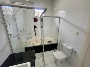 uma casa de banho com um chuveiro, um WC e um lavatório. em Casa completa, suíte master com closet em Macapá