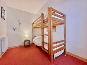 a bedroom with a bunk bed with a ladder at Charmant duplex 6 pers au cœur du village avec piscine et parking - FR-1-505-192 in Notre-Dame-de-Bellecombe