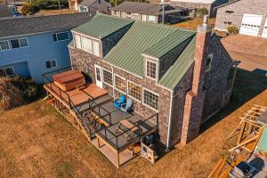 an overhead view of a house with a green roof at Pacific City River House Loft in Pacific City
