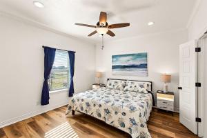 a bedroom with a bed and a ceiling fan at The Breezy Turtle in Crystal Beach